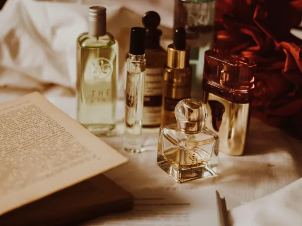 Perfume bottles and an open book on a table