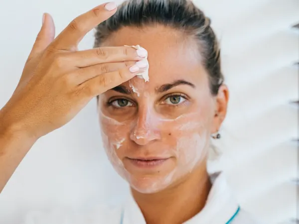 Woman applying cream as part of her skincare routine