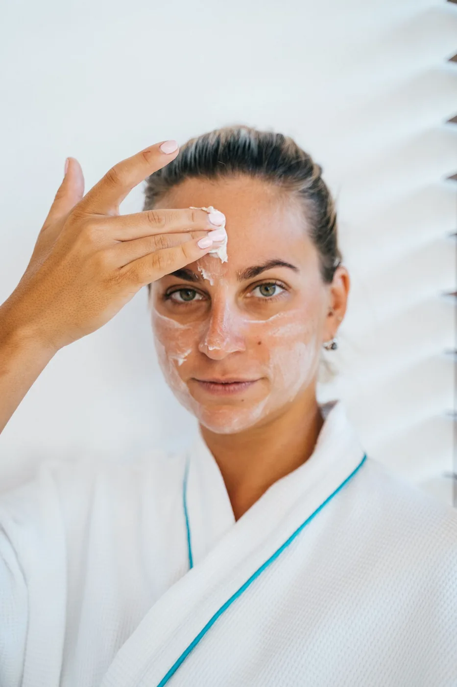Woman applying cream as part of her skincare routine