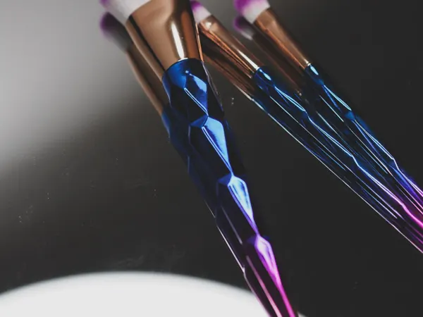 Makeup brushes arranged on a reflective surface
