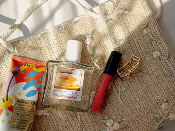 Cosmetic products arranged on an embroidered beauty bag