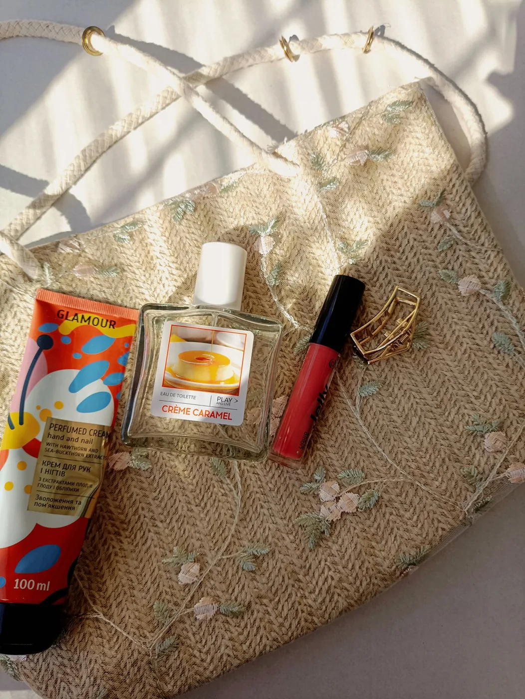 Cosmetic products arranged on an embroidered beauty bag