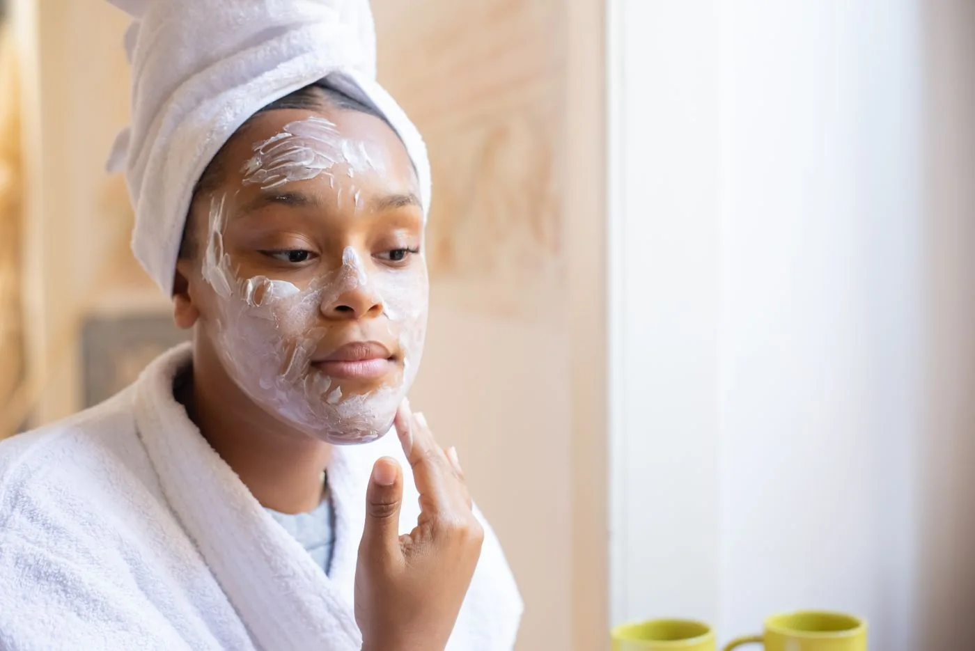 Woman applying face cream in her morning routine