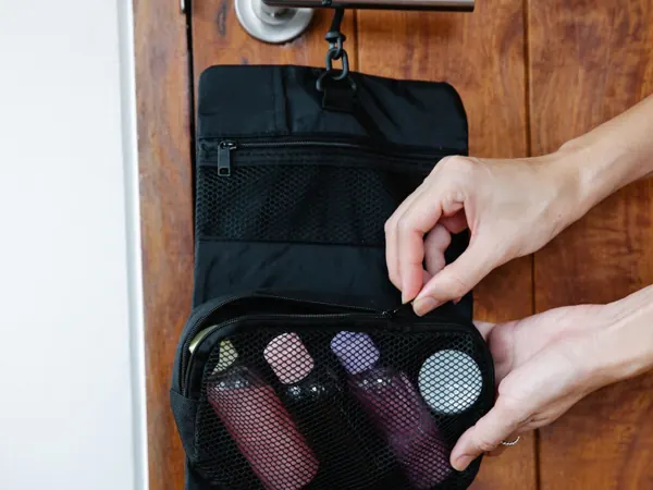 A hanging toiletry bag organized for travel