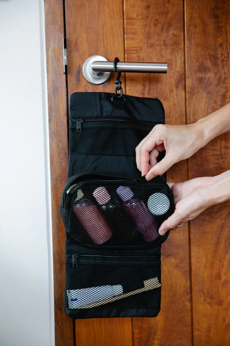 A hanging toiletry bag organized for travel