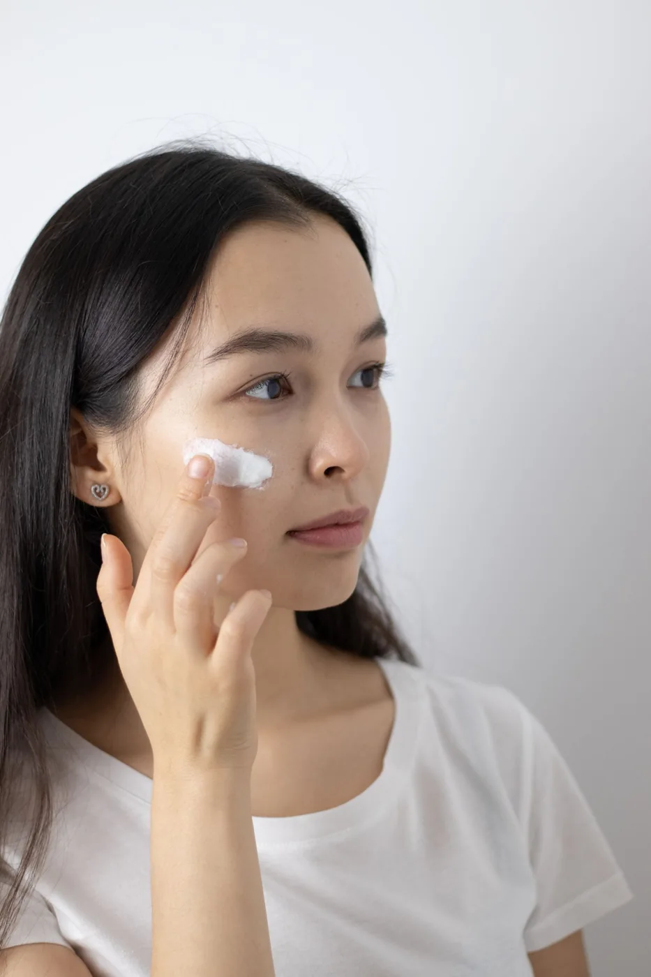 Woman applying a skincare product to her face